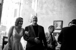 Father walking daughter down aisle black and white